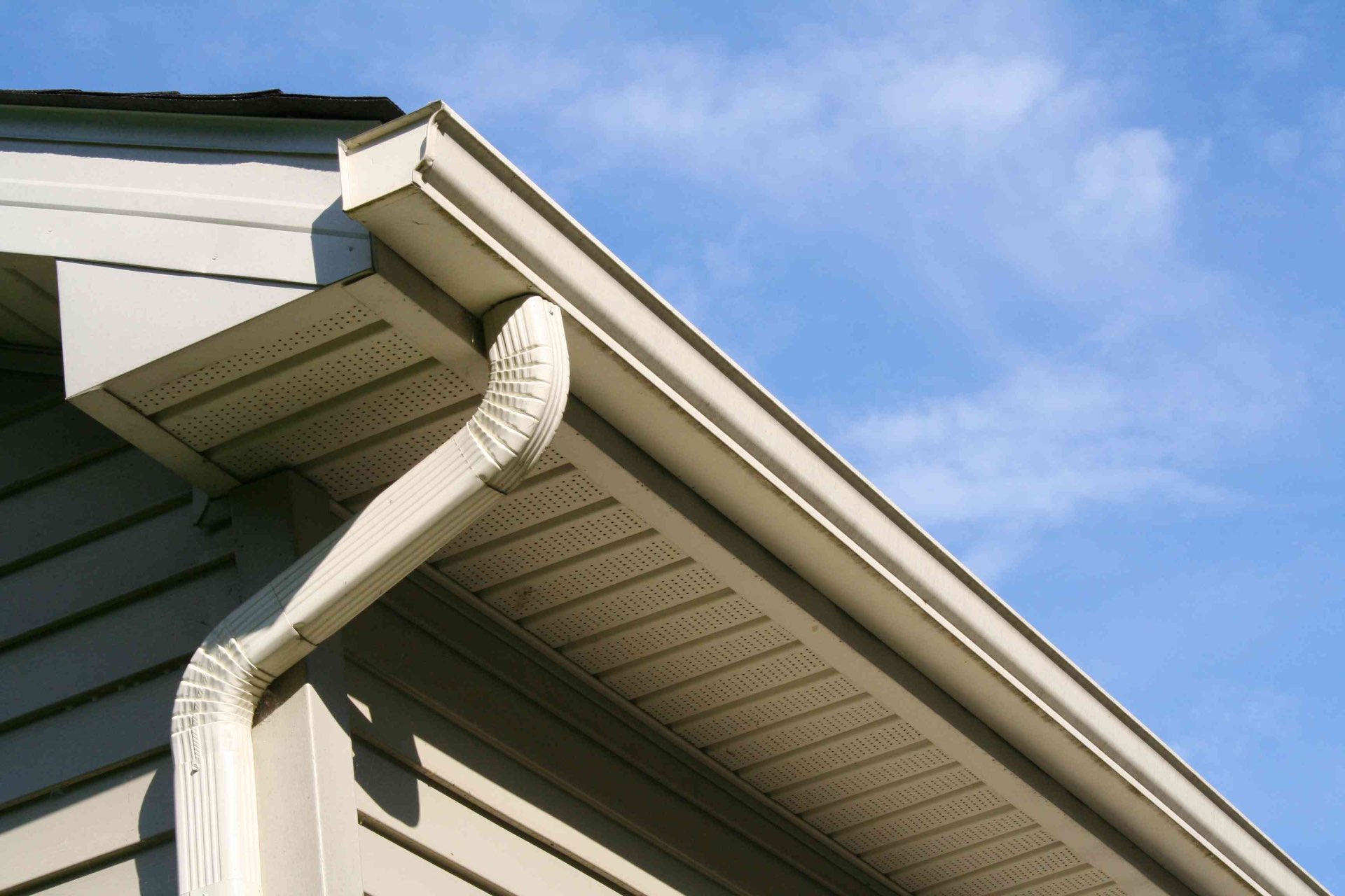 Clean cream seamless gutter installation on a residential home