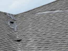 Wind-lifted and damaged asphalt shingles